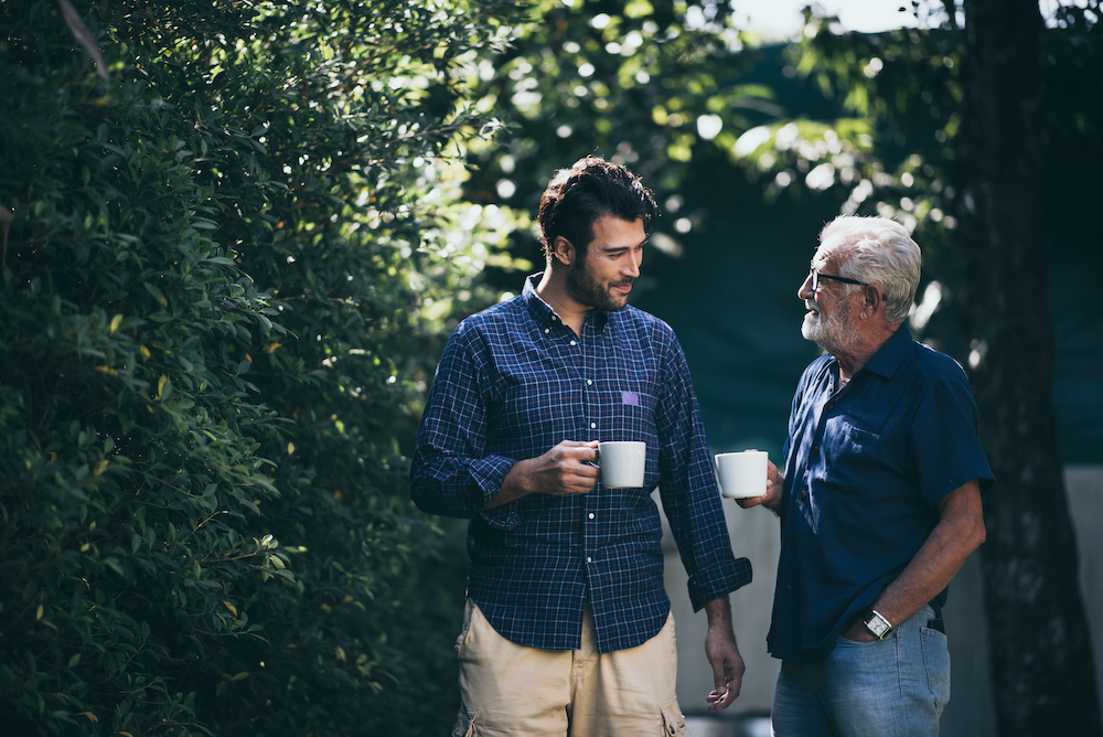 Older adult enjoying walk with caregiver